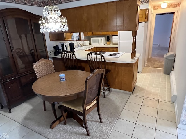 2927 E 8th St, Anderson, IN 46012 - dining room with light tile patterned floors and baseboard heating