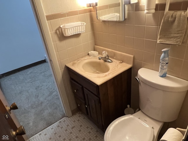 2927 E 8th St, Anderson, IN 46012 - bathroom featuring toilet, tile walls, and vanity