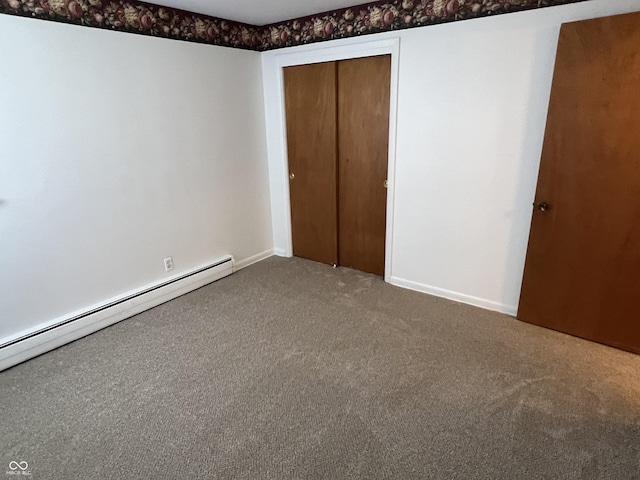 2927 E 8th St, Anderson, IN 46012 - unfurnished bedroom with carpet floors, baseboard heating, a closet, and baseboards
