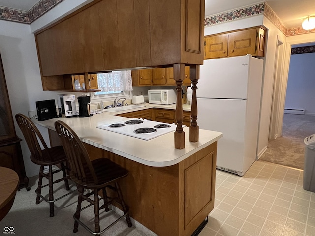 2927 E 8th St, Anderson, IN 46012 - kitchen featuring white appliances, a sink, a peninsula, a baseboard radiator, and brown cabinets