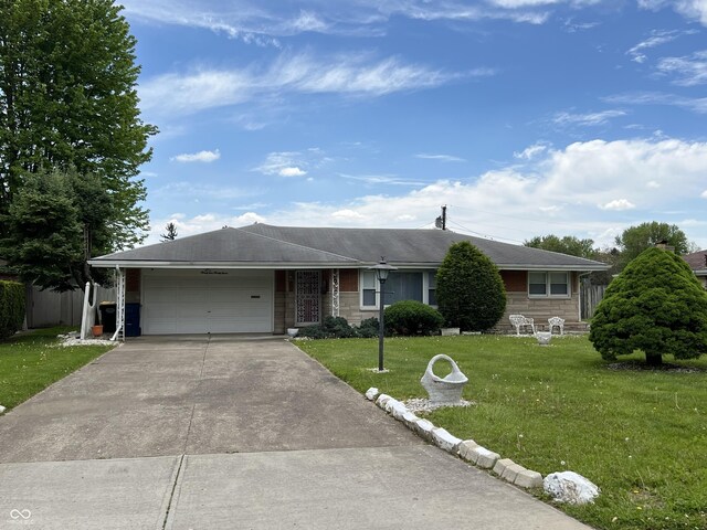 2927 E 8th St, Anderson, IN 46012 - ranch-style house with a garage, a front yard, and concrete driveway