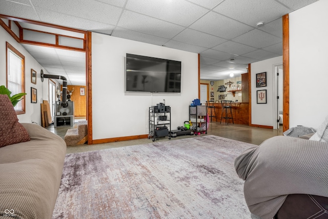 bedroom with a paneled ceiling and baseboards