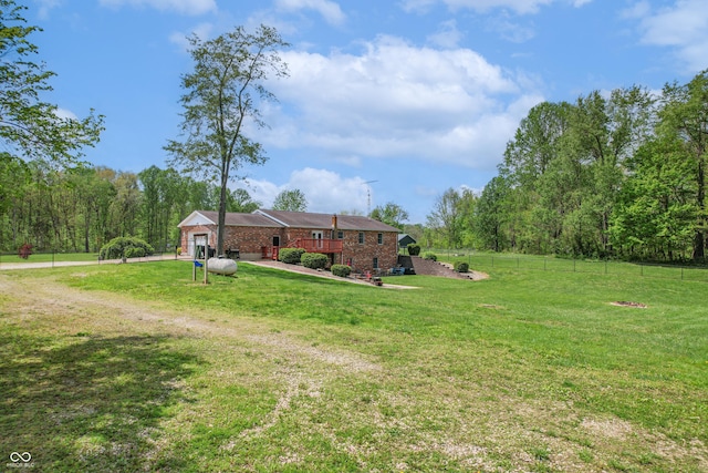 view of yard featuring an attached garage and dirt driveway