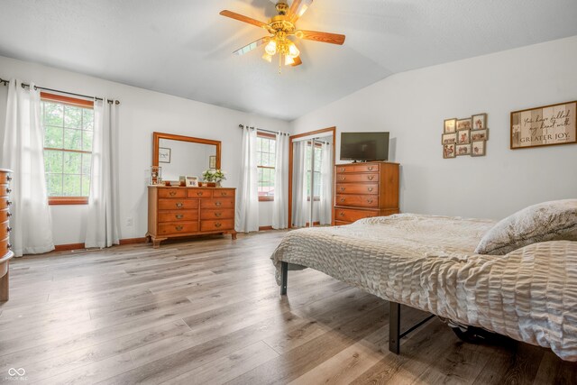 bedroom with lofted ceiling, wood finished floors, ceiling fan, and baseboards