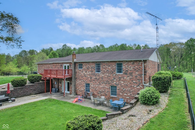 rear view of property with a patio, brick siding, central air condition unit, a deck, and a chimney