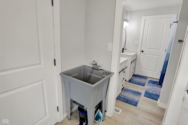 bathroom featuring wood finished floors and vanity