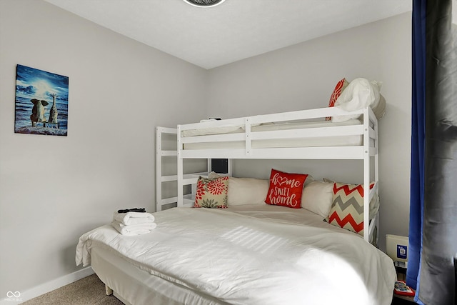 bedroom with baseboards and carpet floors