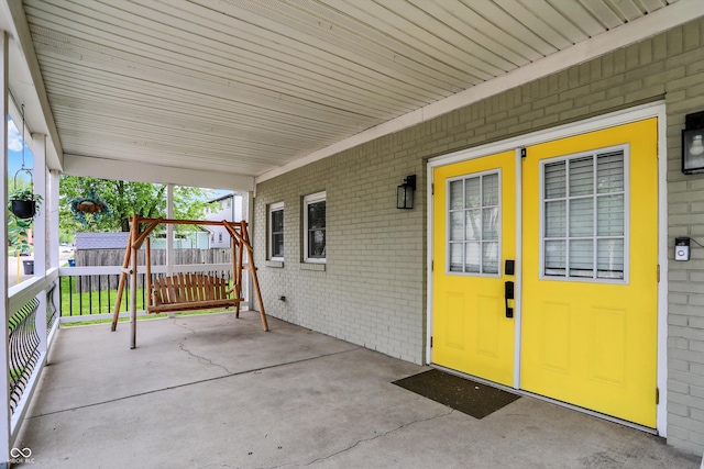 view of patio / terrace featuring fence and an outbuilding