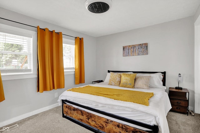 bedroom with carpet flooring and baseboards