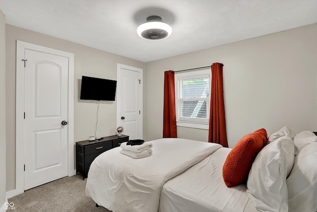 bedroom featuring light colored carpet