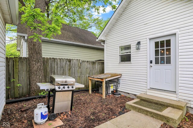 view of patio featuring fence, entry steps, and grilling area