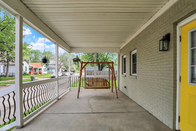 view of patio / terrace with a residential view and covered porch