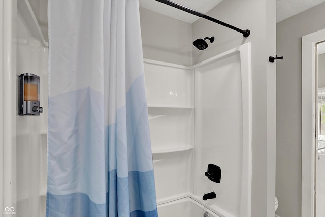 bathroom with shower / bath combination with curtain and toilet