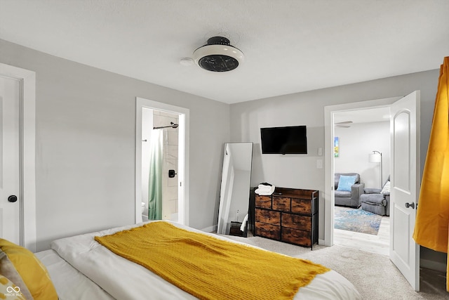 carpeted bedroom featuring connected bathroom