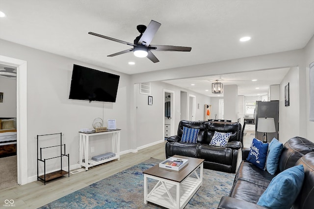 living area with a ceiling fan, light wood finished floors, recessed lighting, and baseboards
