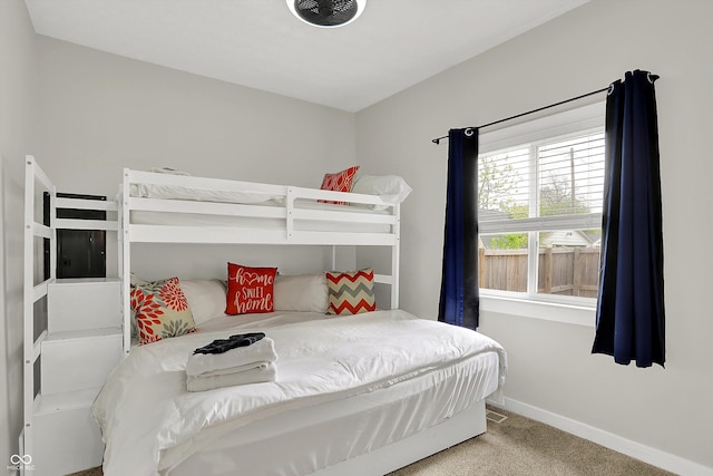carpeted bedroom featuring baseboards