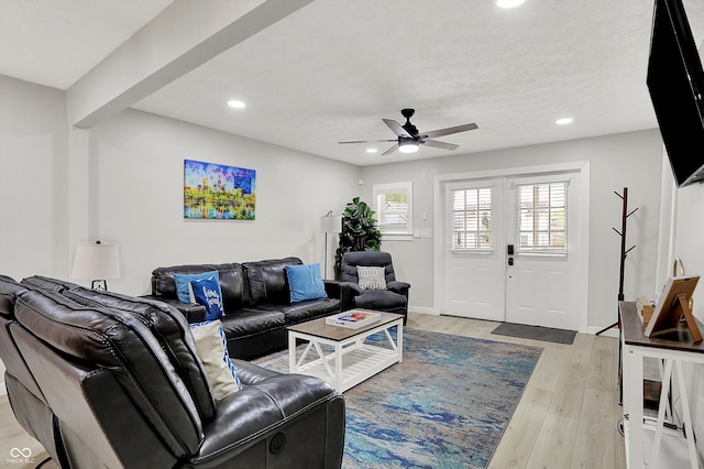living area featuring recessed lighting, light wood-style flooring, and a ceiling fan