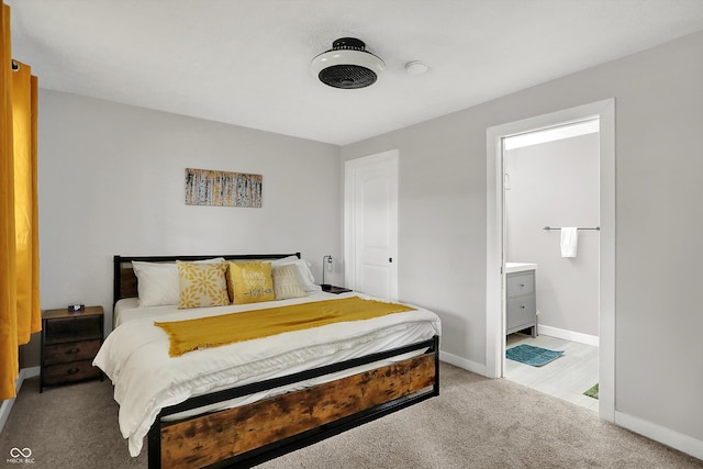 bedroom with baseboards, carpet, and ensuite bathroom