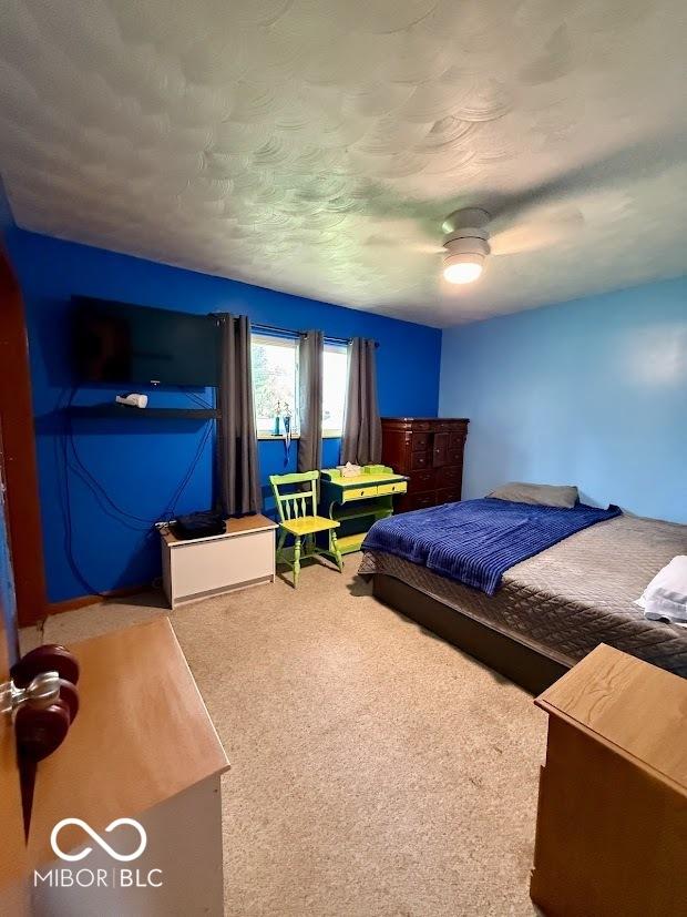 bedroom with carpet floors and a ceiling fan