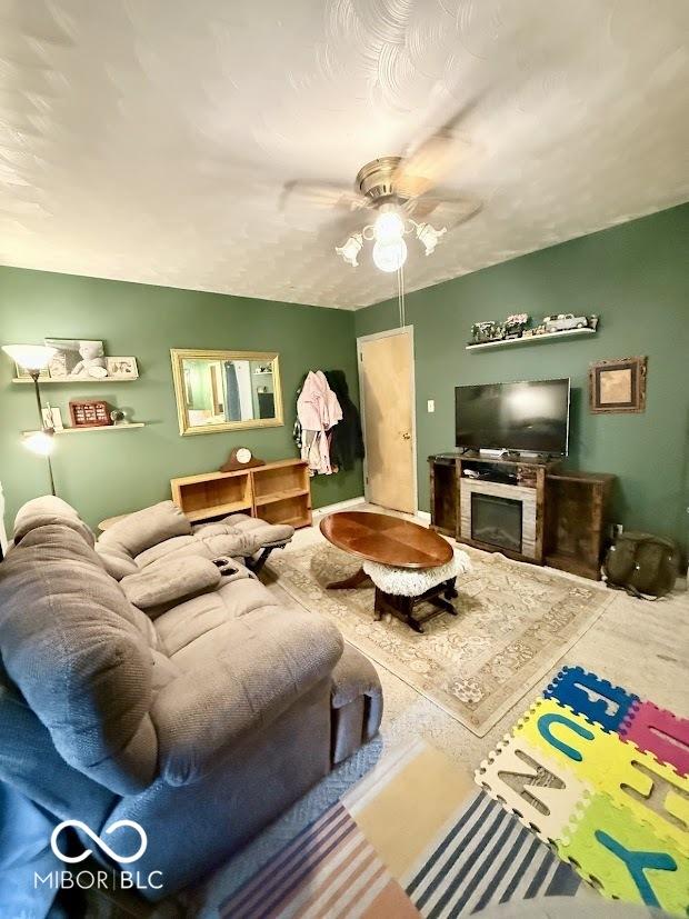 living area with a ceiling fan