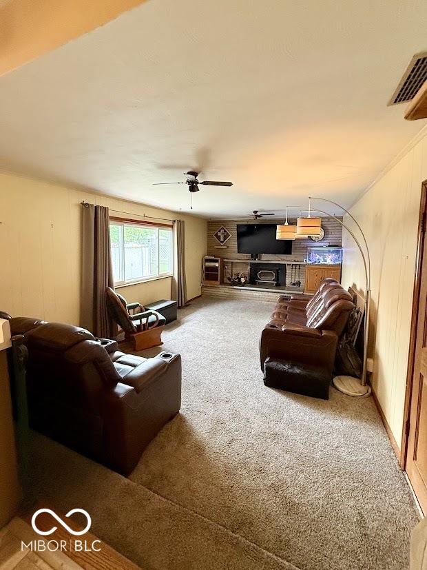 carpeted living room with ceiling fan