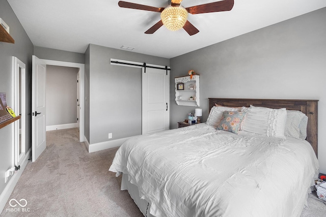 629 Perry Ln, West Lafayette, IN 47906 - bedroom featuring a barn door, carpet flooring, baseboards, a closet, and a ceiling fan