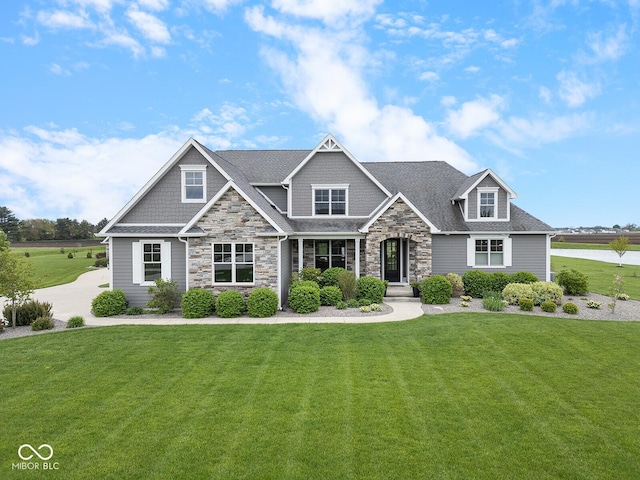 629 Perry Ln, West Lafayette, IN 47906 - craftsman-style house with stone siding, a front lawn, and roof with shingles