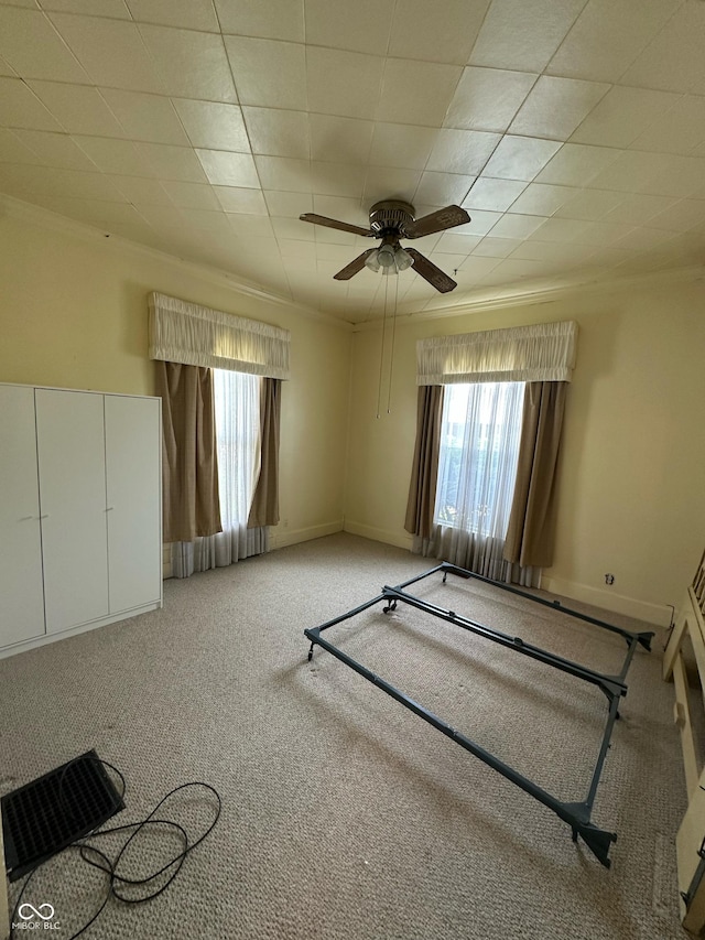803 W 12th St, Anderson, IN 46016 - empty room with ornamental molding, healthy amount of natural light, a ceiling fan, carpet floors, and baseboards