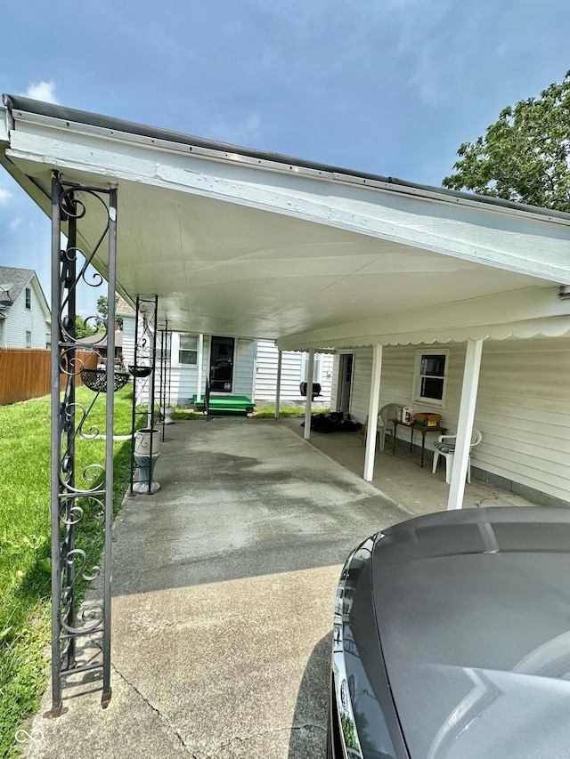 803 W 12th St, Anderson, IN 46016 - view of vehicle parking with an attached carport and concrete driveway