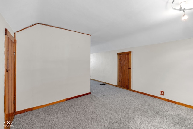 bonus room featuring carpet, baseboards, and lofted ceiling