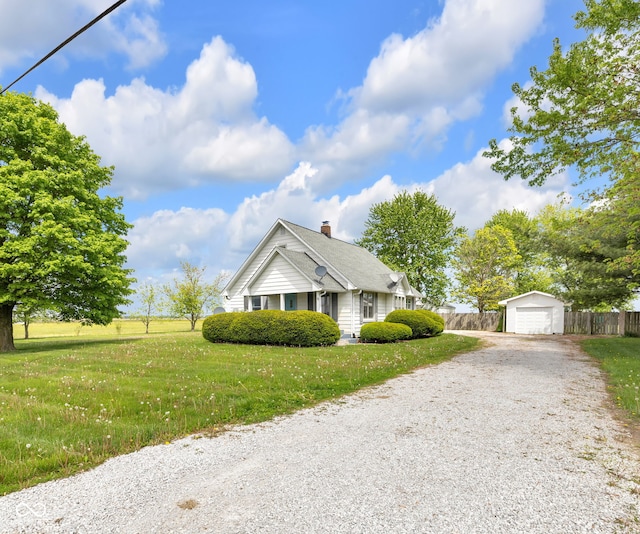 view of front facade with an outdoor structure, gravel driveway, a garage, and a chimney