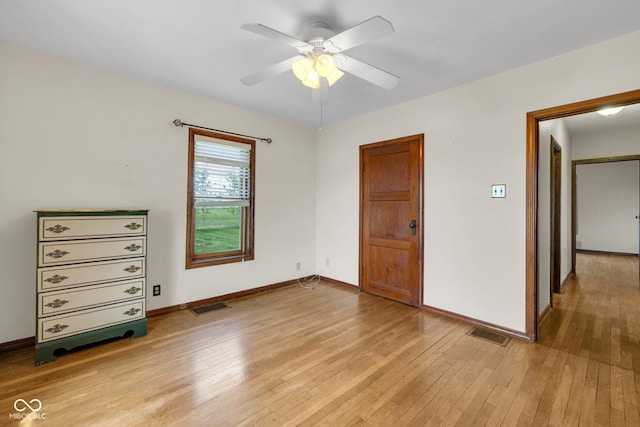 unfurnished bedroom featuring light wood-type flooring, baseboards, and ceiling fan