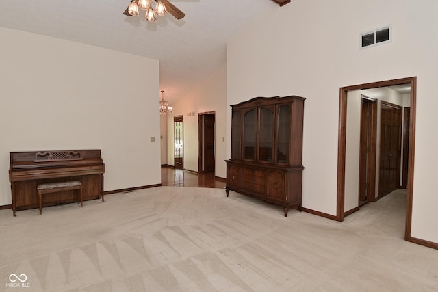 5361 Carnoustie Cir, Avon, IN 46123 - unfurnished room featuring baseboards, light carpet, a chandelier, ceiling fan, and high vaulted ceiling