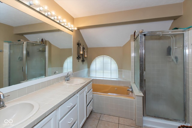 full bathroom with a shower stall, lofted ceiling, tile patterned flooring, a garden tub, and double vanity