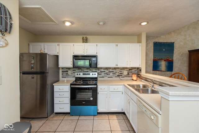 kitchen featuring appliances with stainless steel finishes, a sink, light countertops, and white cabinets