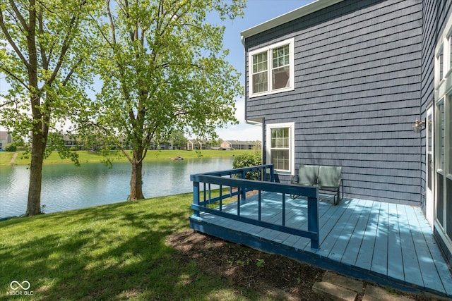 wooden deck with a yard and a water view