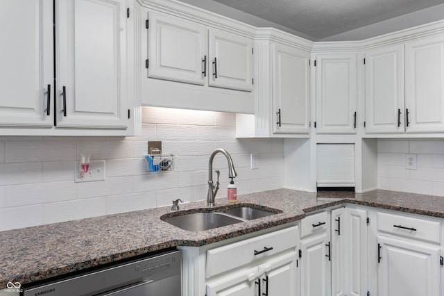 kitchen featuring dishwasher, a sink, white cabinets, and a textured ceiling