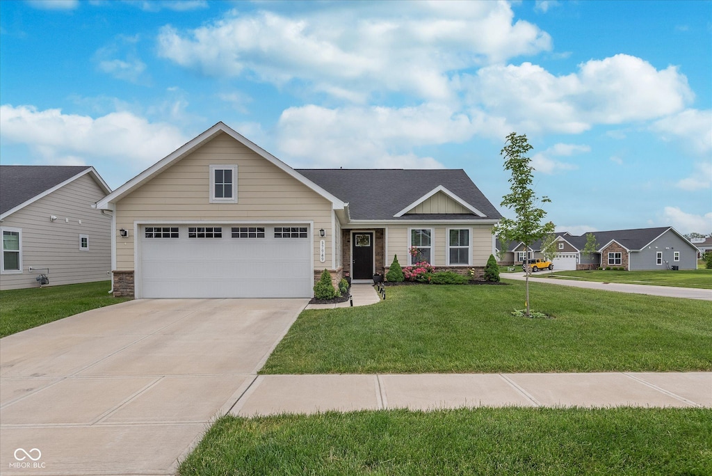 17949 Scout Ln, Westfield, IN 46074 - view of front facade featuring a garage, stone siding, driveway, and a front yard