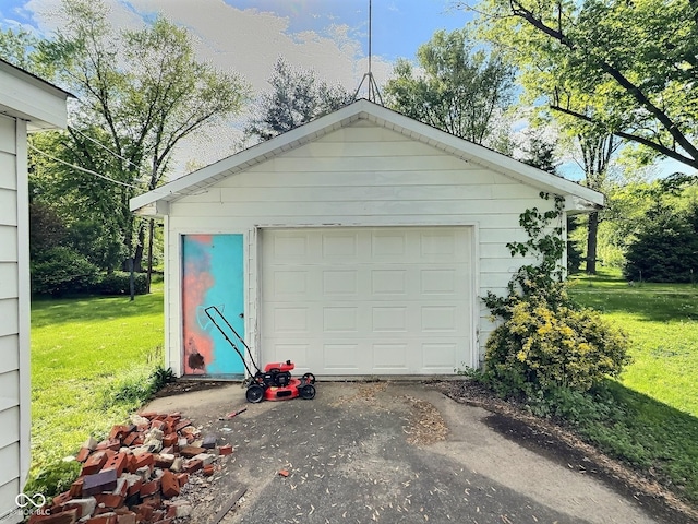 detached garage featuring asphalt driveway