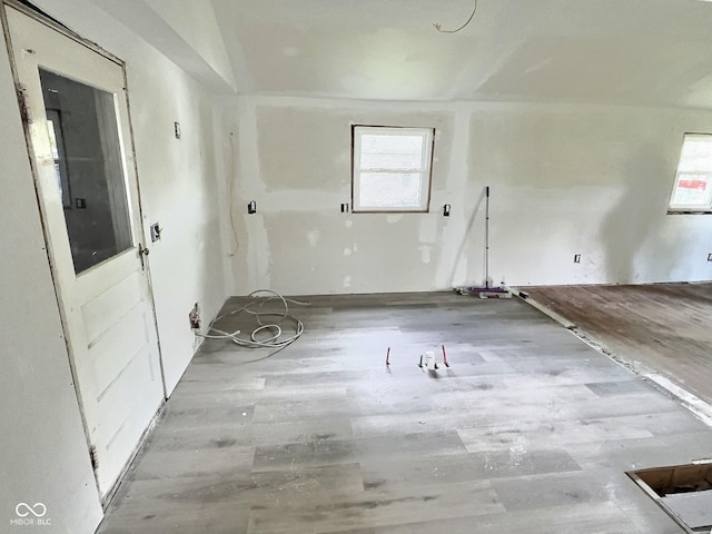 empty room with healthy amount of natural light and wood finished floors