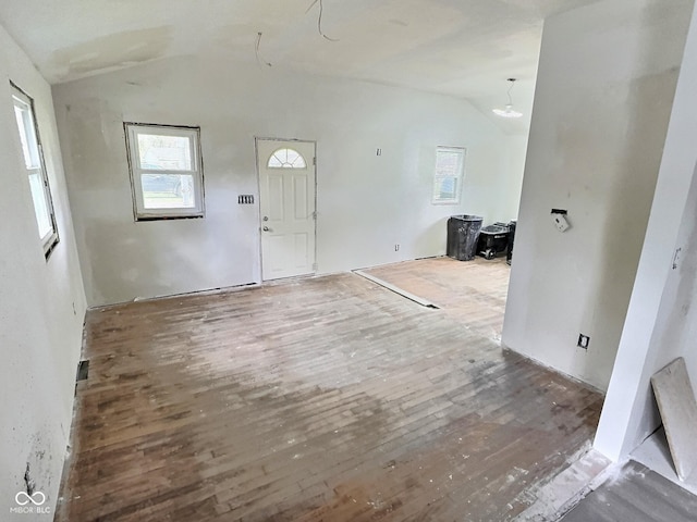 foyer entrance with vaulted ceiling and wood finished floors