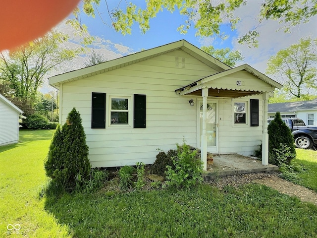 rear view of property with a yard