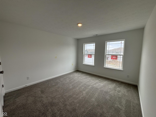 unfurnished room featuring carpet flooring and baseboards