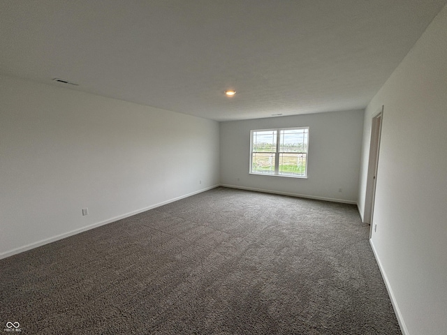 carpeted empty room with baseboards and recessed lighting