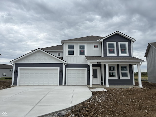 view of front of home featuring driveway, covered porch, a garage, and roof with shingles