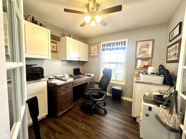 office featuring dark wood finished floors, a ceiling fan, a textured ceiling, and baseboards