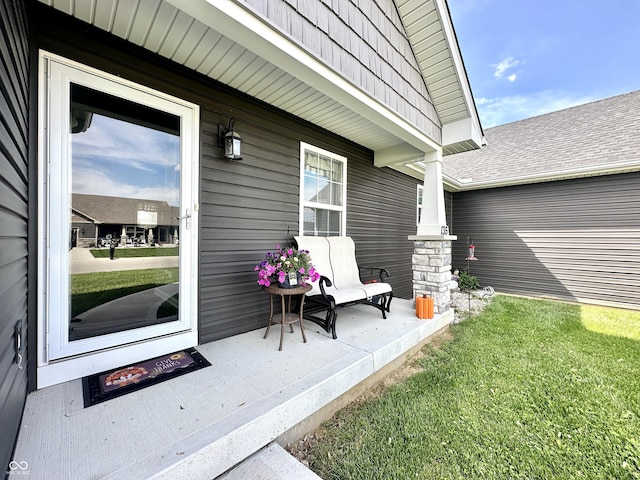 property entrance featuring covered porch and a yard
