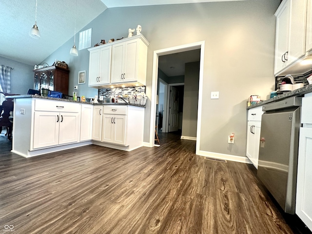 kitchen featuring dark countertops, a peninsula, lofted ceiling, dark wood-type flooring, and white cabinets