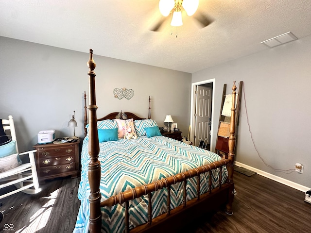 bedroom with wood finished floors, baseboards, a ceiling fan, and a textured ceiling