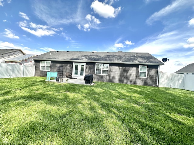 back of property featuring french doors, a patio area, and a shingled roof